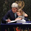 John Kerry podpisuje Pariški sporazum z vnukinjo v naročju
