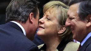 Britain's Prime Minister Cameron greets Germany's Chancellor Merkel while EC Pre