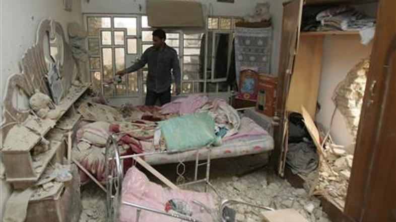 Prebivalec stoji v poškodovani hiši po ameriškem letalskem napadu na Bagdad 31. 
