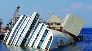 razno 12.09.13. The capsized cruise liner Costa Concordia lies surrounded by cra