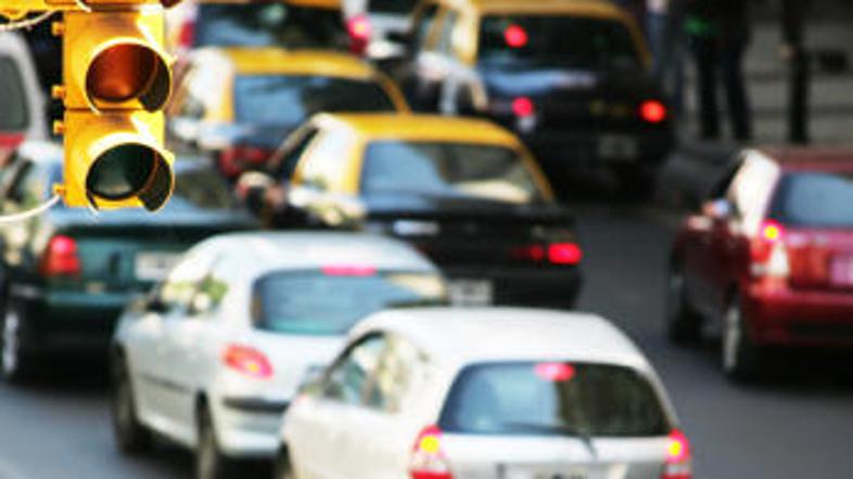 Policist, ki ni na nujni vožnji, pred vašim avtomobilom zapelje v rdečo luč. Mu 