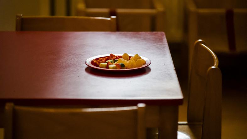 miza v vrtcu na njej je krožnik sadja