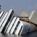 razno 12.09.13. The capsized cruise liner Costa Concordia lies surrounded by cra