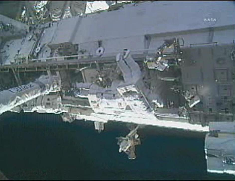 Popravilo ISS astronavta
