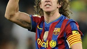 Sport 28.11.10, Barcelona's captain Carles Puyol celebrates after their Spanish 