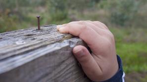 otroška roka zarjavel žebelj