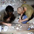razno 19.11.13. droga, narkoman, Men prepare to inject heroin at an abandoned ho