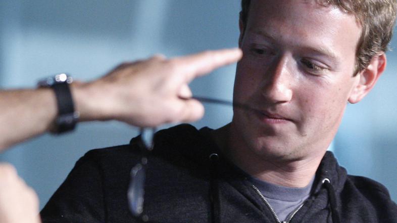 Interviewer James Bennet points to an audience member as Facebook CEO Mark Zucke