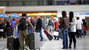 razno 17.05.13. turisti, letalisce, Passengers with their baggage move through t