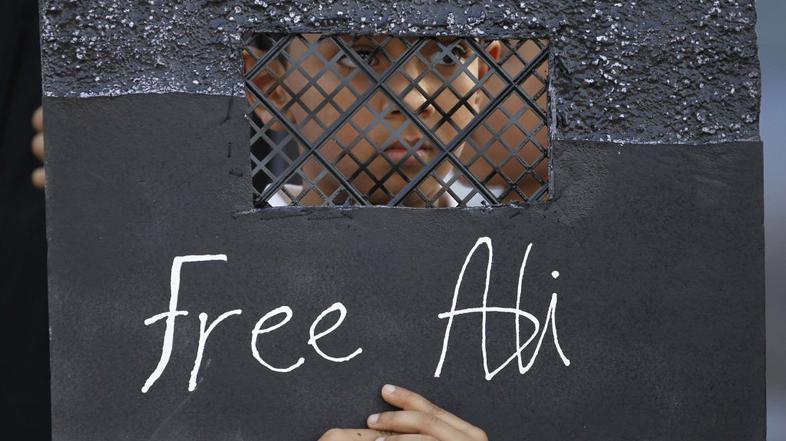 Deček na protestih proti priprtju 12-letnega Alija Hasana, obtoženega protestira