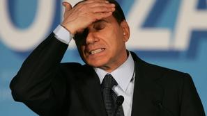 Italian Prime Minister Silvio Berlusconi gestures as he makes a speech during a 