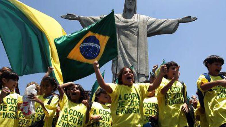 Mladi Brazilci navdušeno slavijo pridobitev organizacije SP v nogometu.